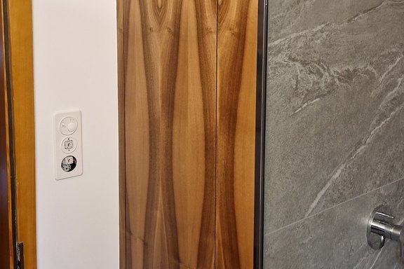 Neuer Einbauschrank mit Nussbaumholz und laufender Holzstruktur